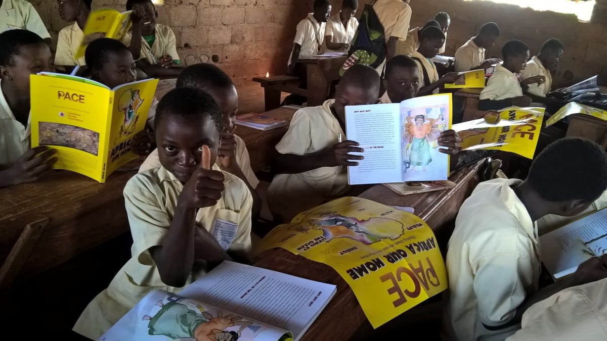 Child with thumbs up with PACE book